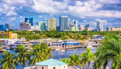 "Aerial view of Fort Lauderdale with waterfront homes, boats, and city skyline